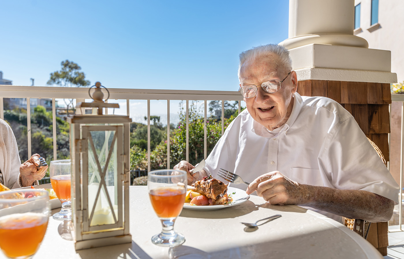 A person eating on the patio.