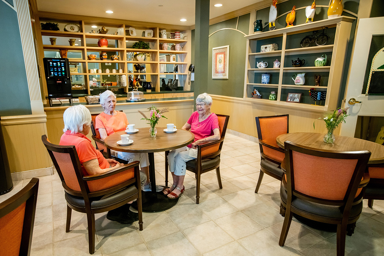 Residents are sitting in the cafe at East Village Place.