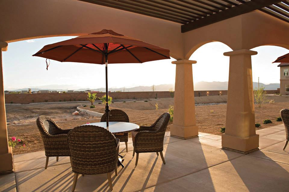 Outdoor patio with a table, chairs and umbrella.