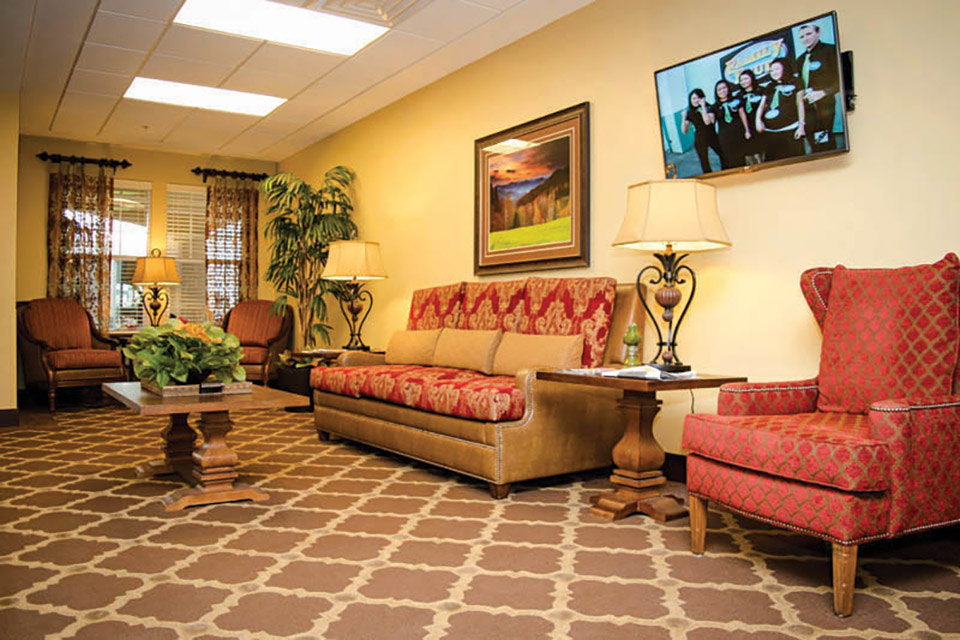 Lobby with a couch, tables and chairs.