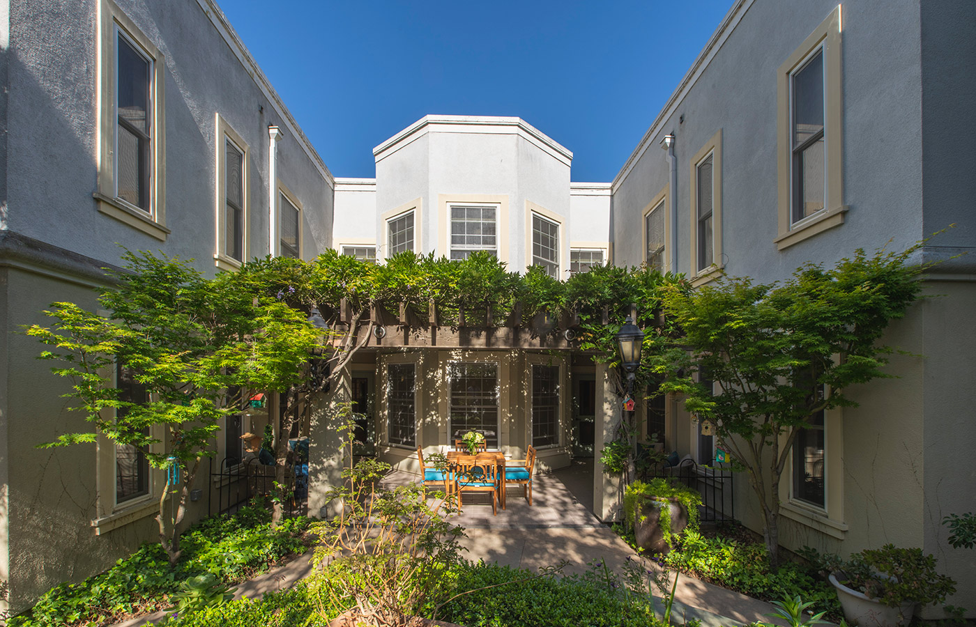 luscious garden with patio table and chairs in the center