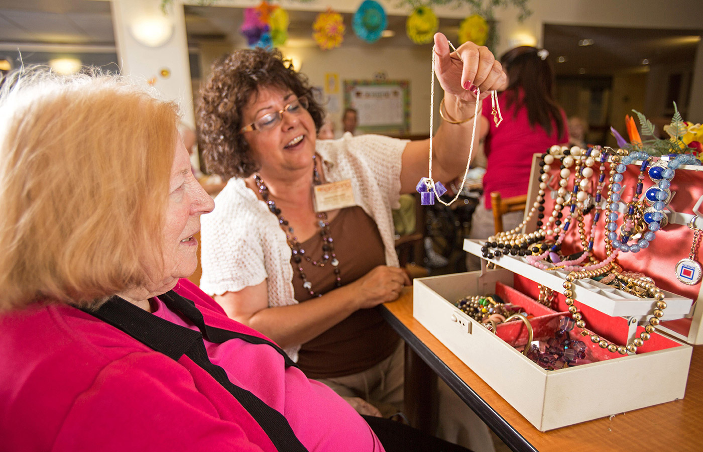 two residents looking at jewelry 