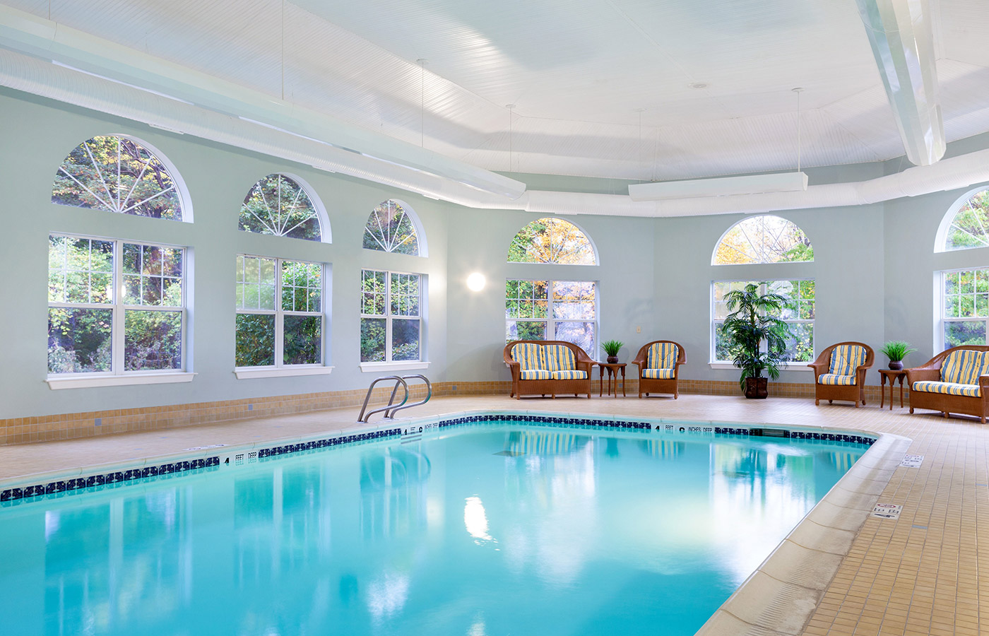 Indoor pool with seating area.