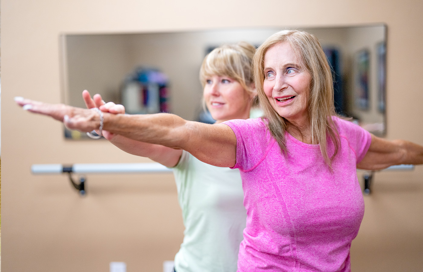 An associate assisting a resident with stretching.