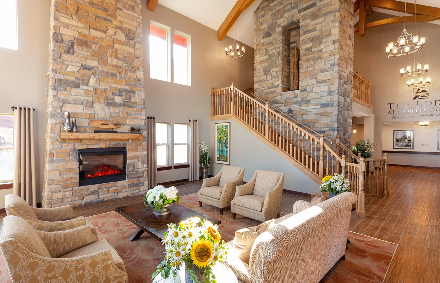 Seating area with staircase at The Lodge at North Ogden. 