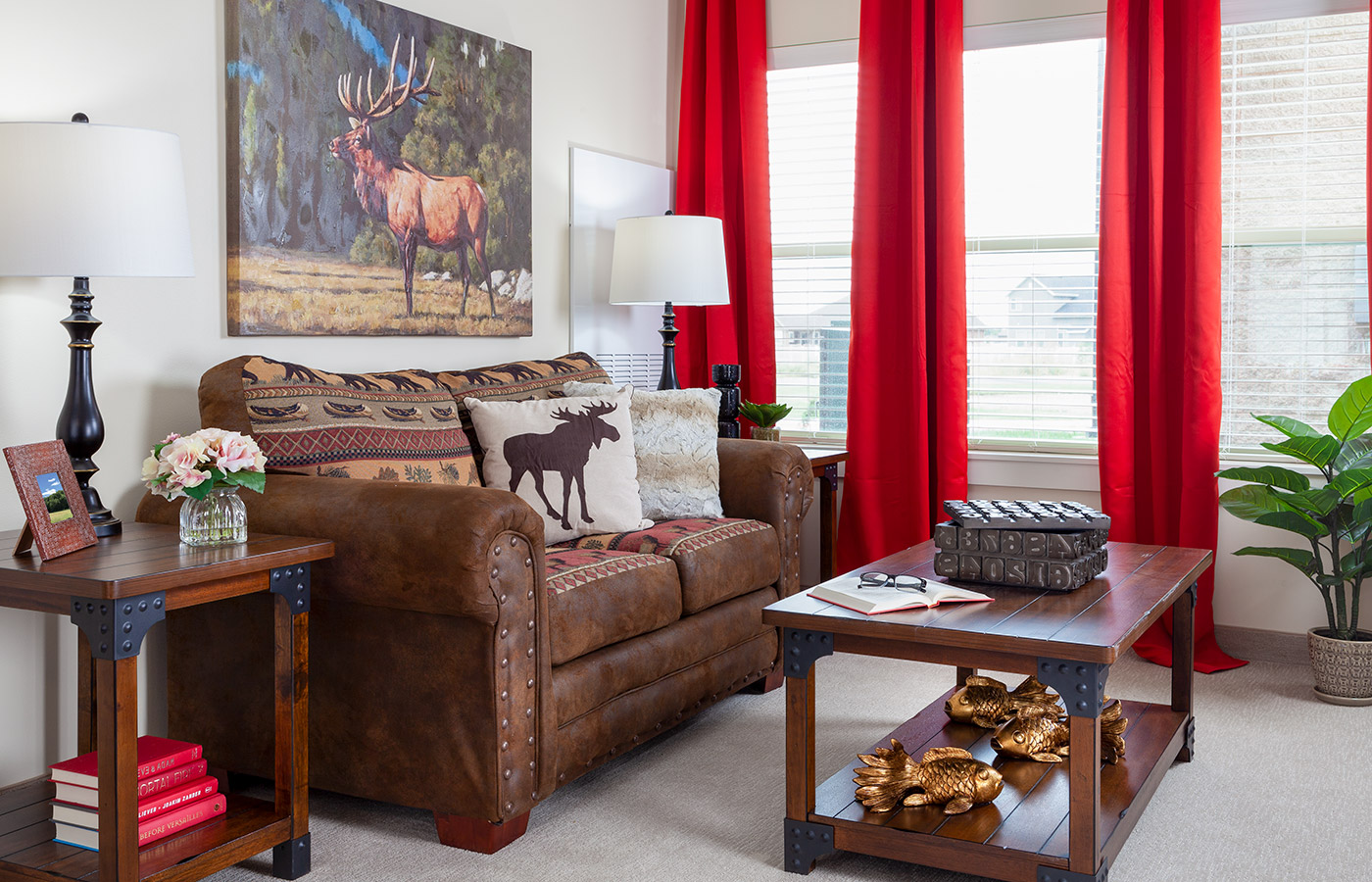 Furnished living room space with sofa, coffee table and chairs.