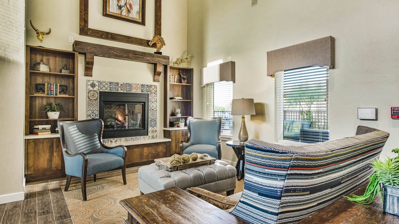 A seating area in front of a fireplace at The Watermark at Continental Ranch.