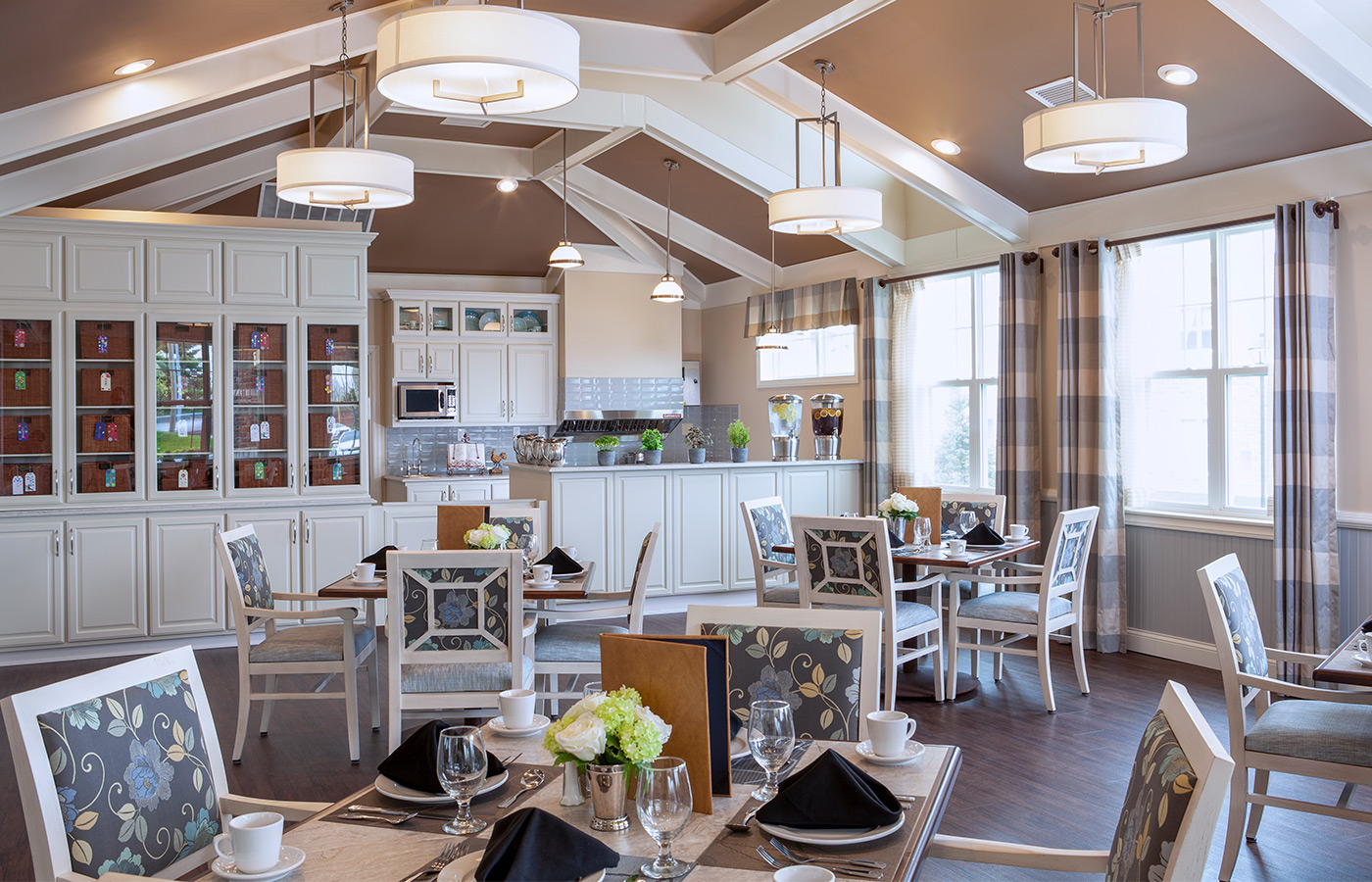 Dining room with seating area including tables and chairs.