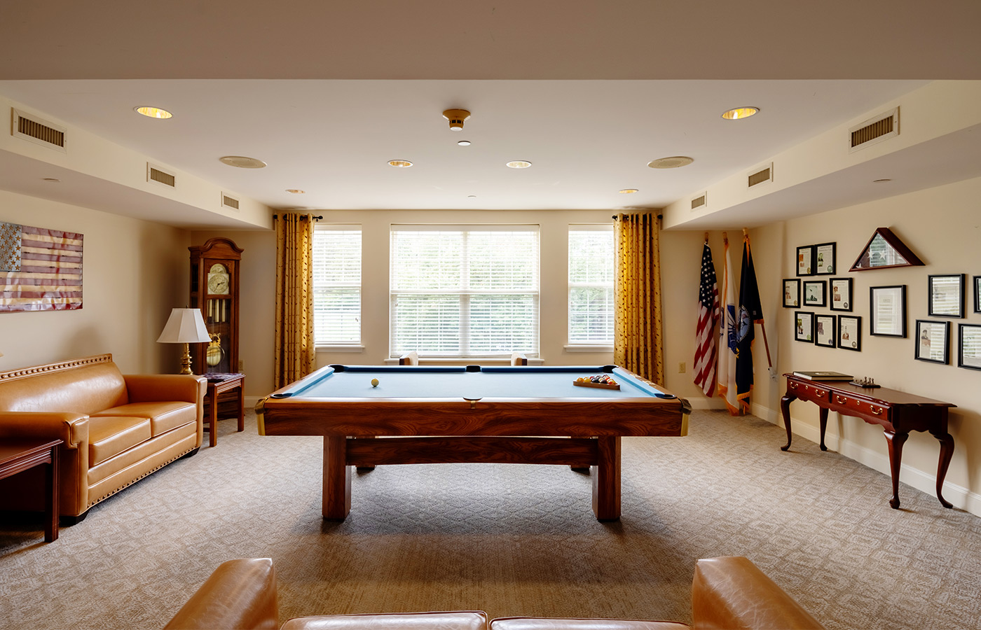 An activity room with a pool table.