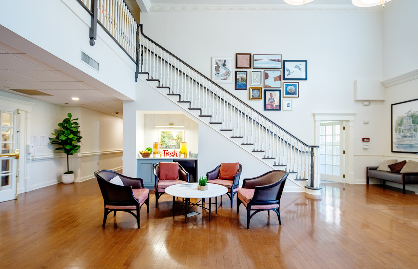 A lobby area with a lemonade and tea station and seating.