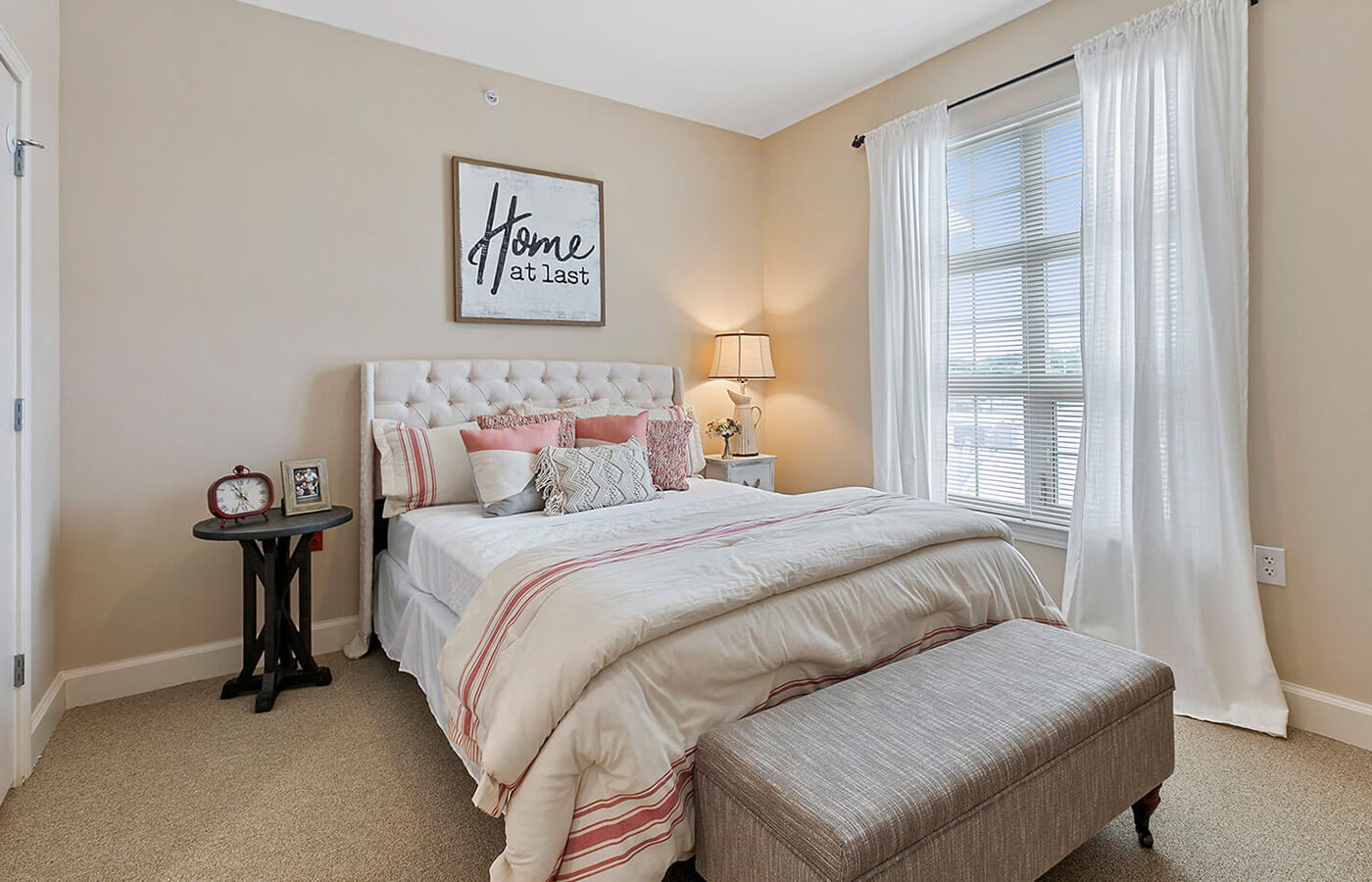 Bedroom with bed by a window.