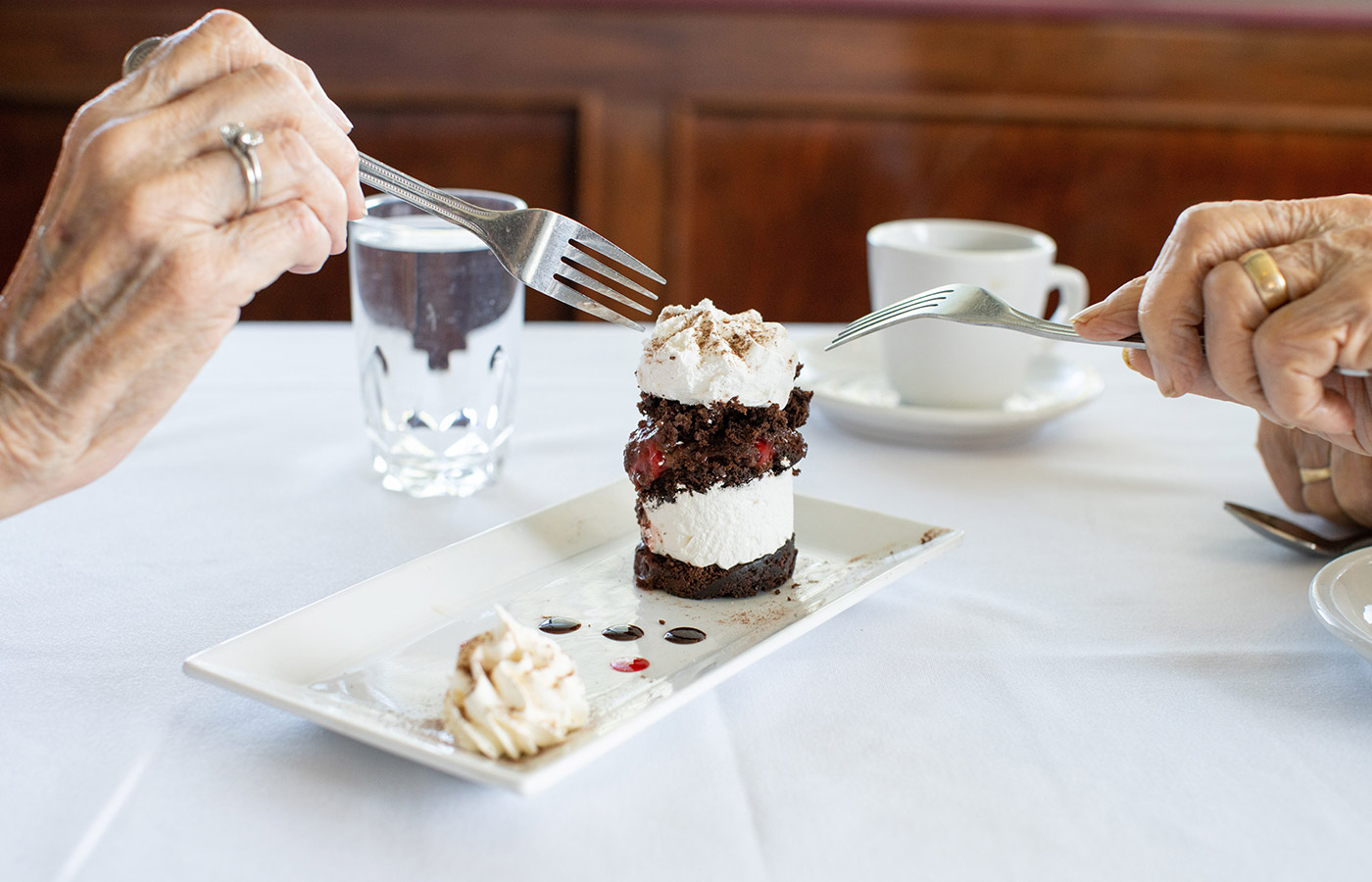 Two residents are sharing a dessert.