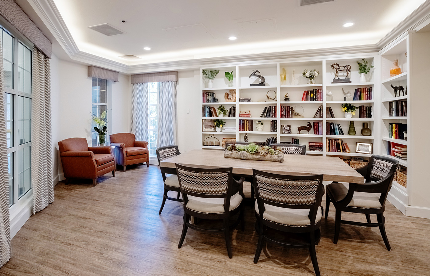 A common area with book shelves and a table.