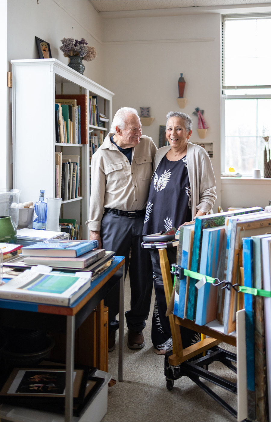 Two people smiling in the art studio.