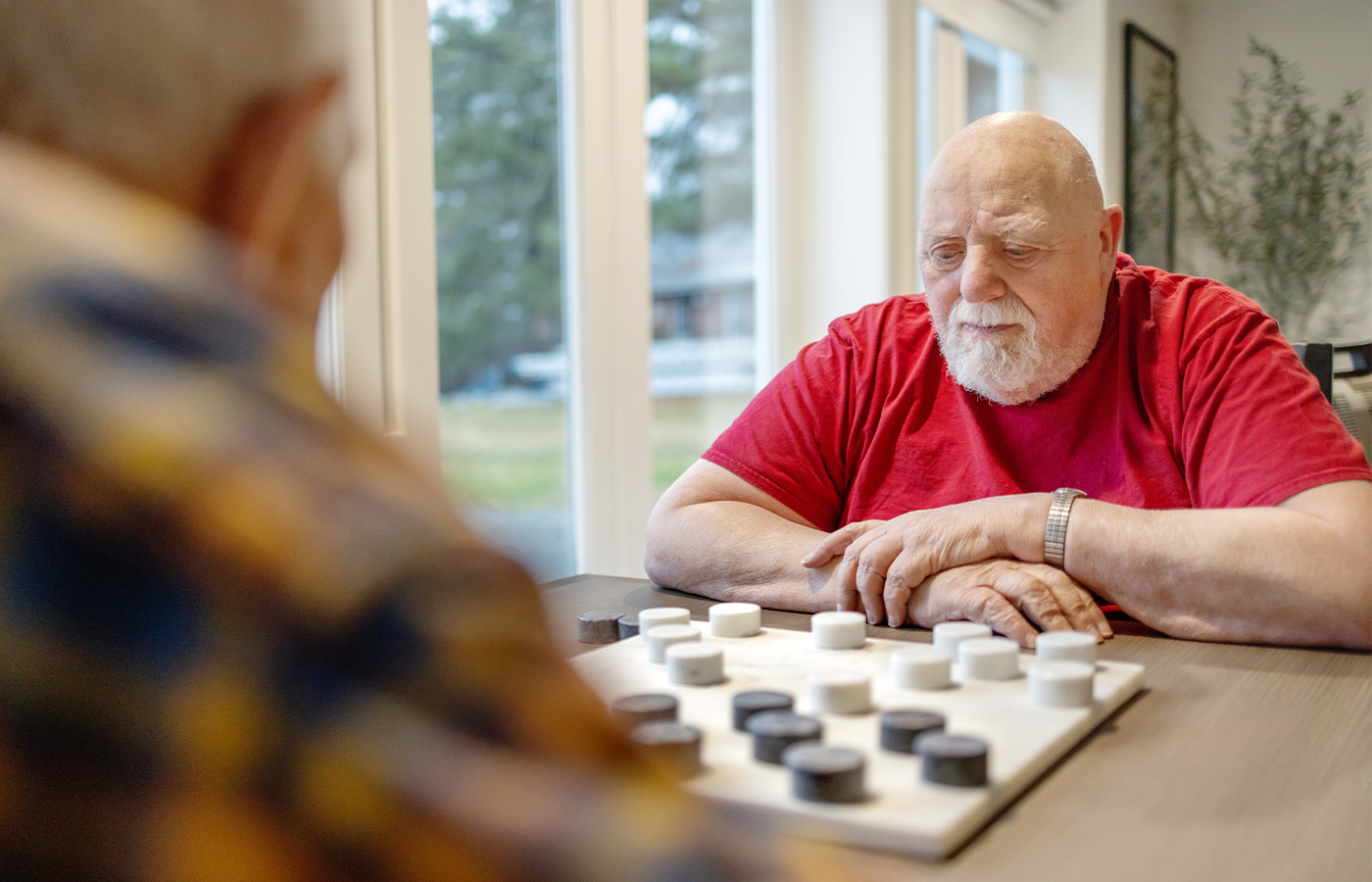 Two people playing checkers.