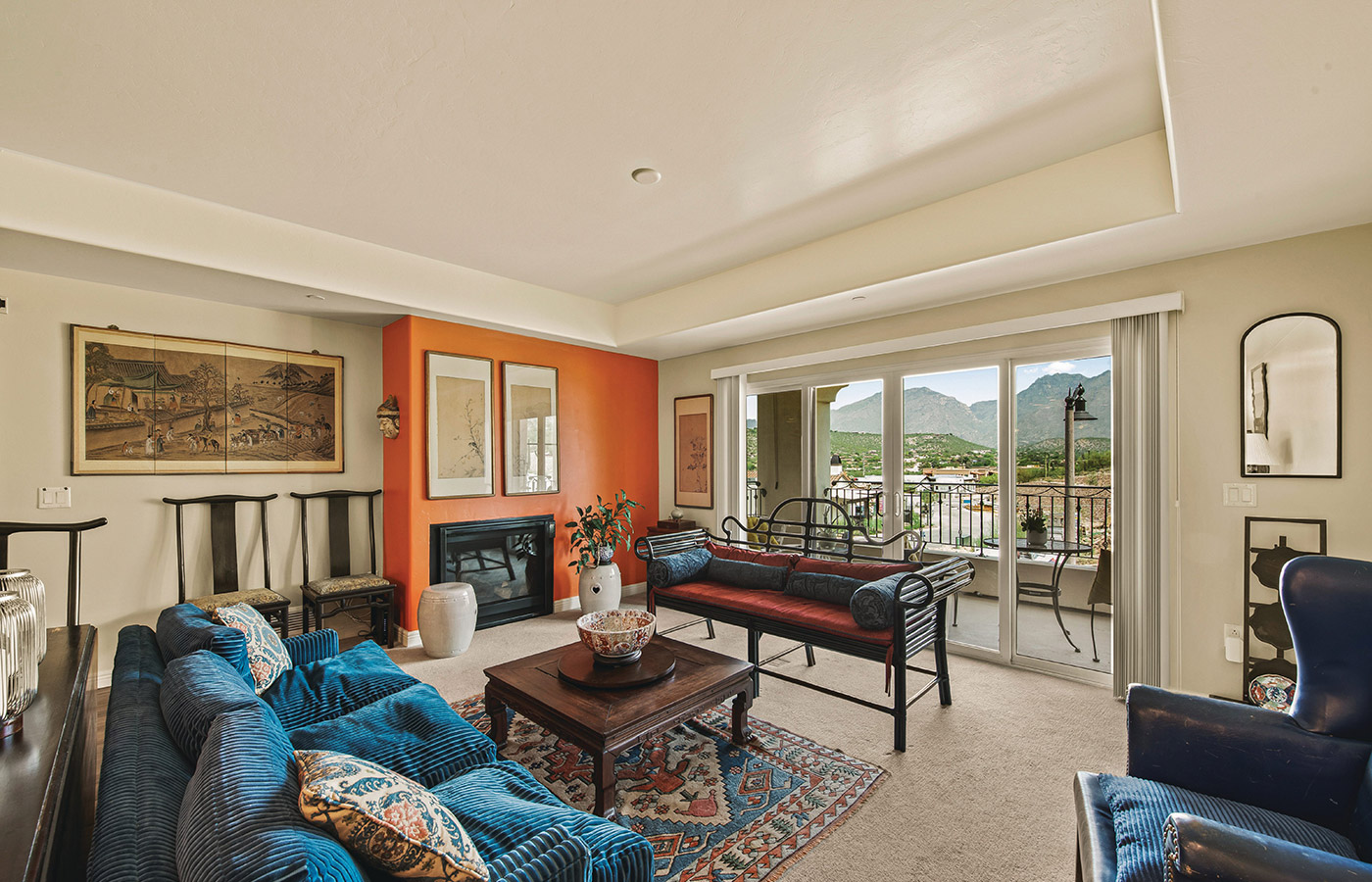 Furnished living room space with sofa, table, and seating area.