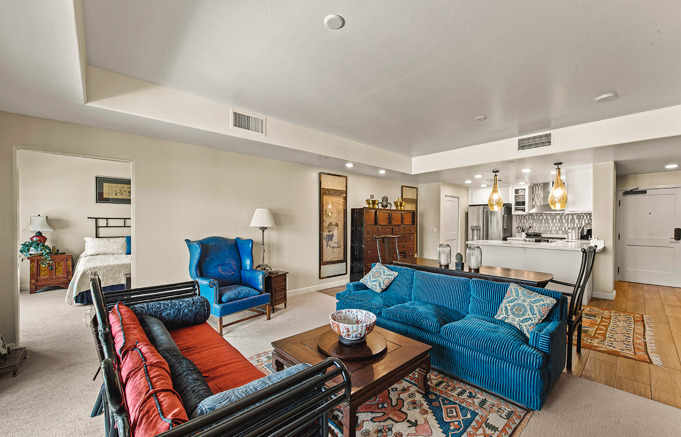 Furnished living room space with sofa, table, and seating area.