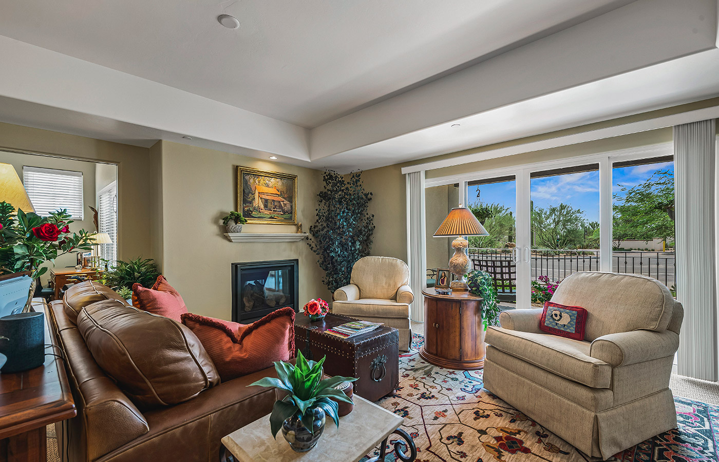 Furnished living room space with sofa, table, and seating area.