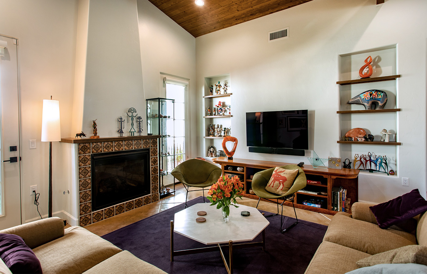 Seating area with sofas, chairs, and tables.