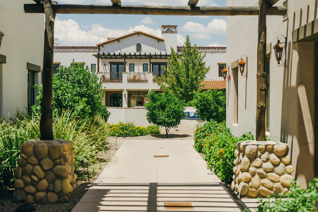 The Hacienda at the River exterior building and courtyard. 