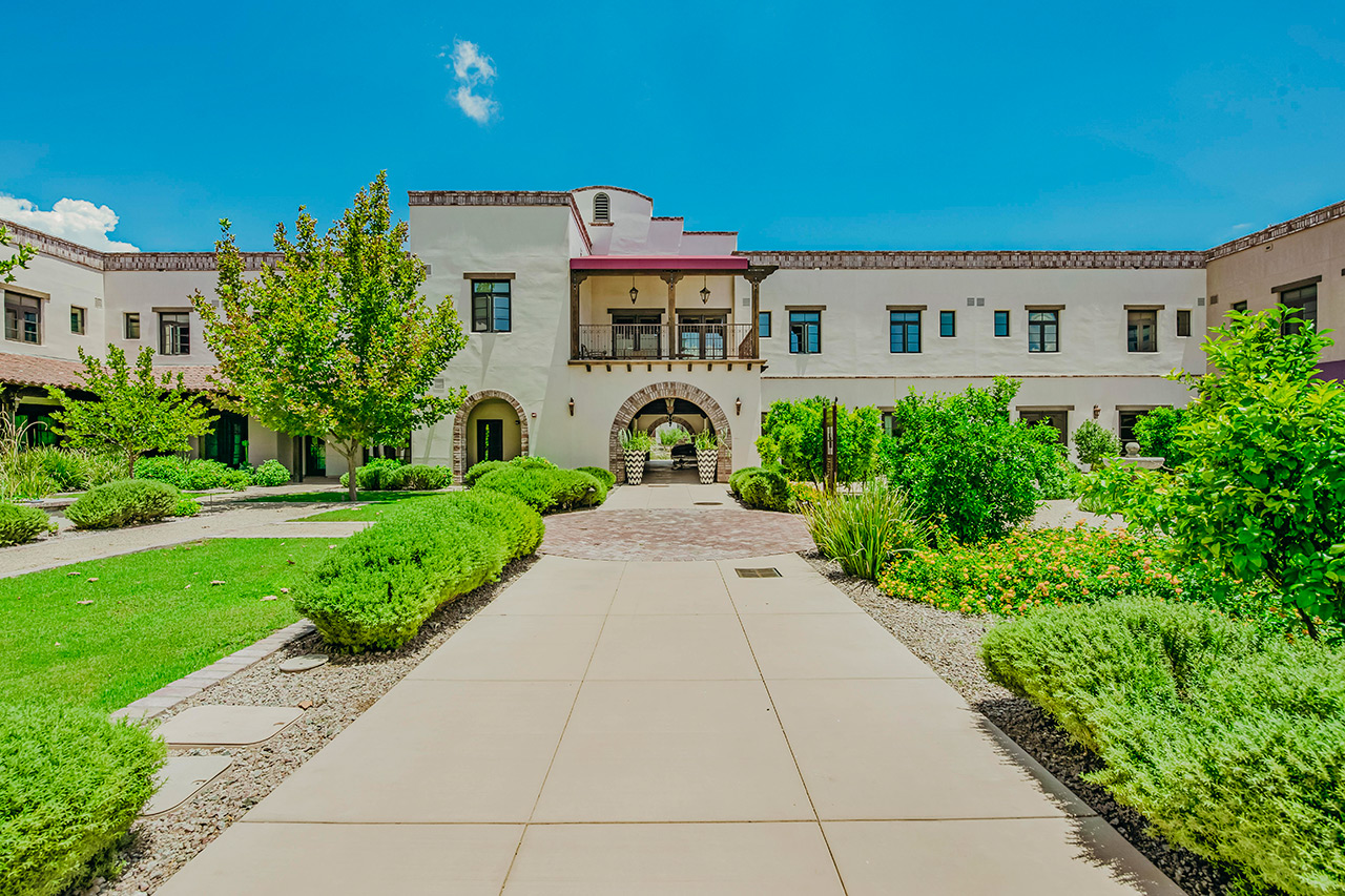 The Hacienda at the River exterior building and courtyard. 