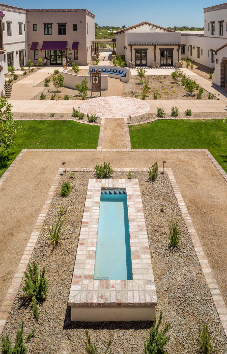 The Hacienda at the River exterior building and courtyard. 
