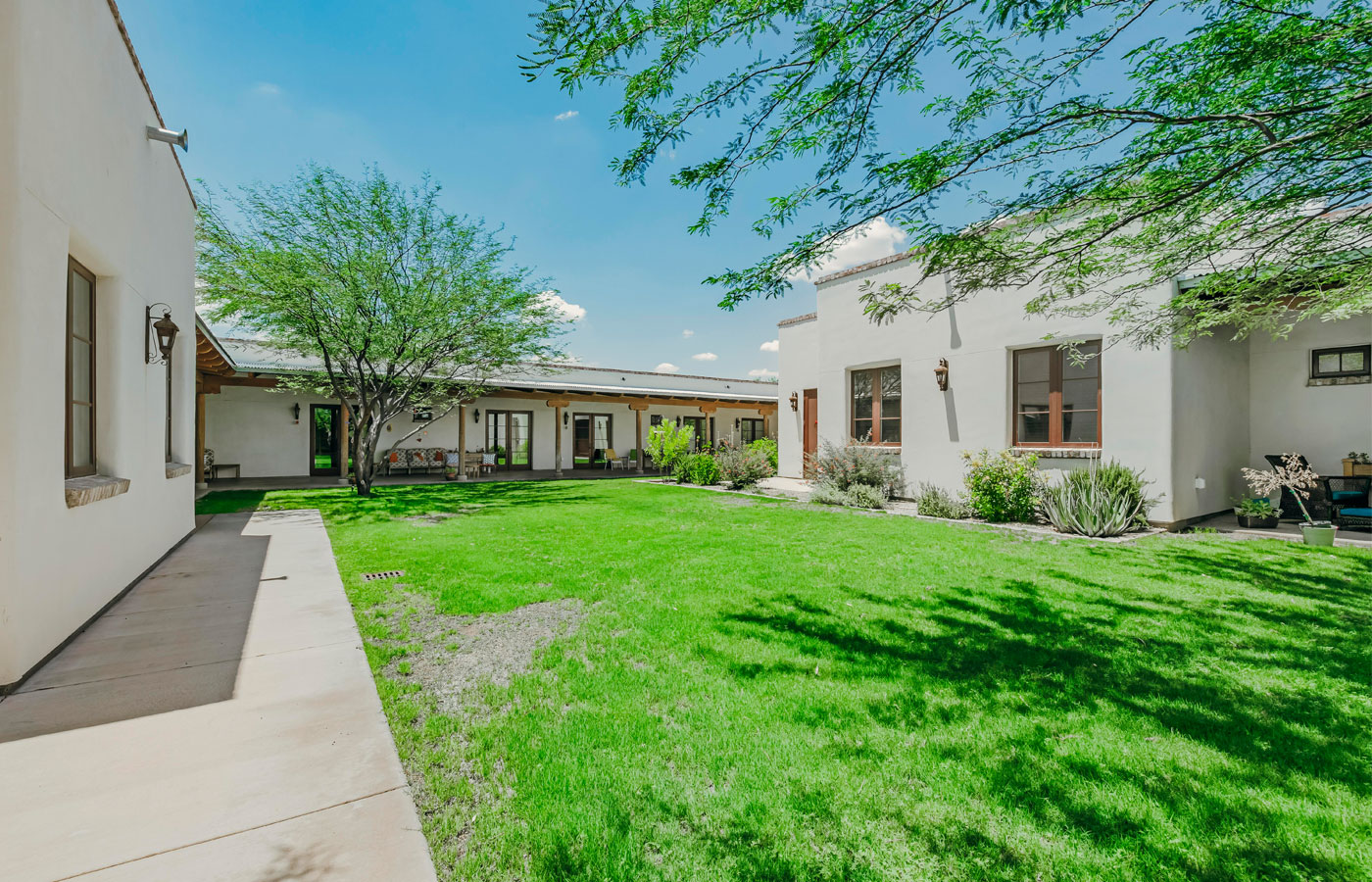 The Hacienda at the River exterior building and courtyard. 
