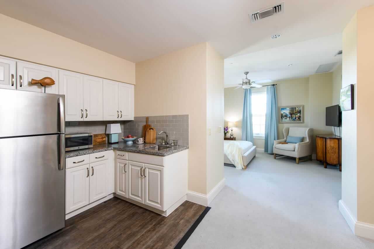 Unit kitchen with living room in the background