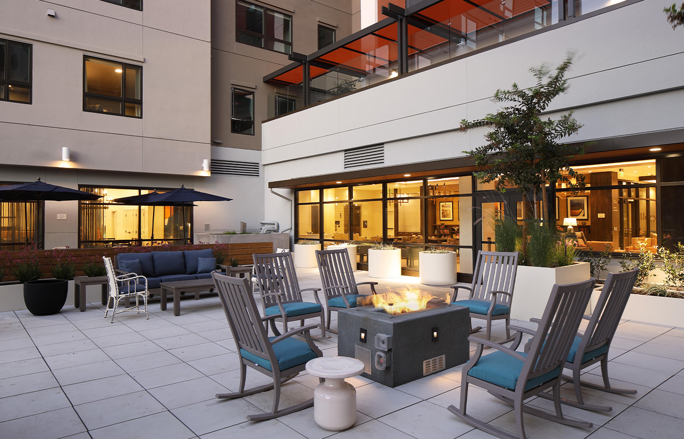 A patio area with a fireplace and seating.