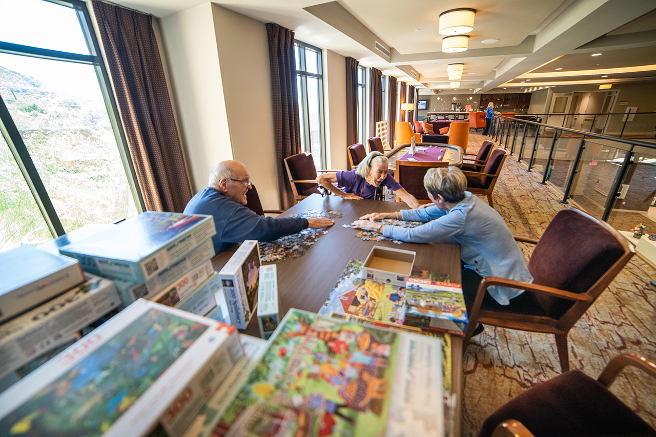 Residents are working together on a puzzle.