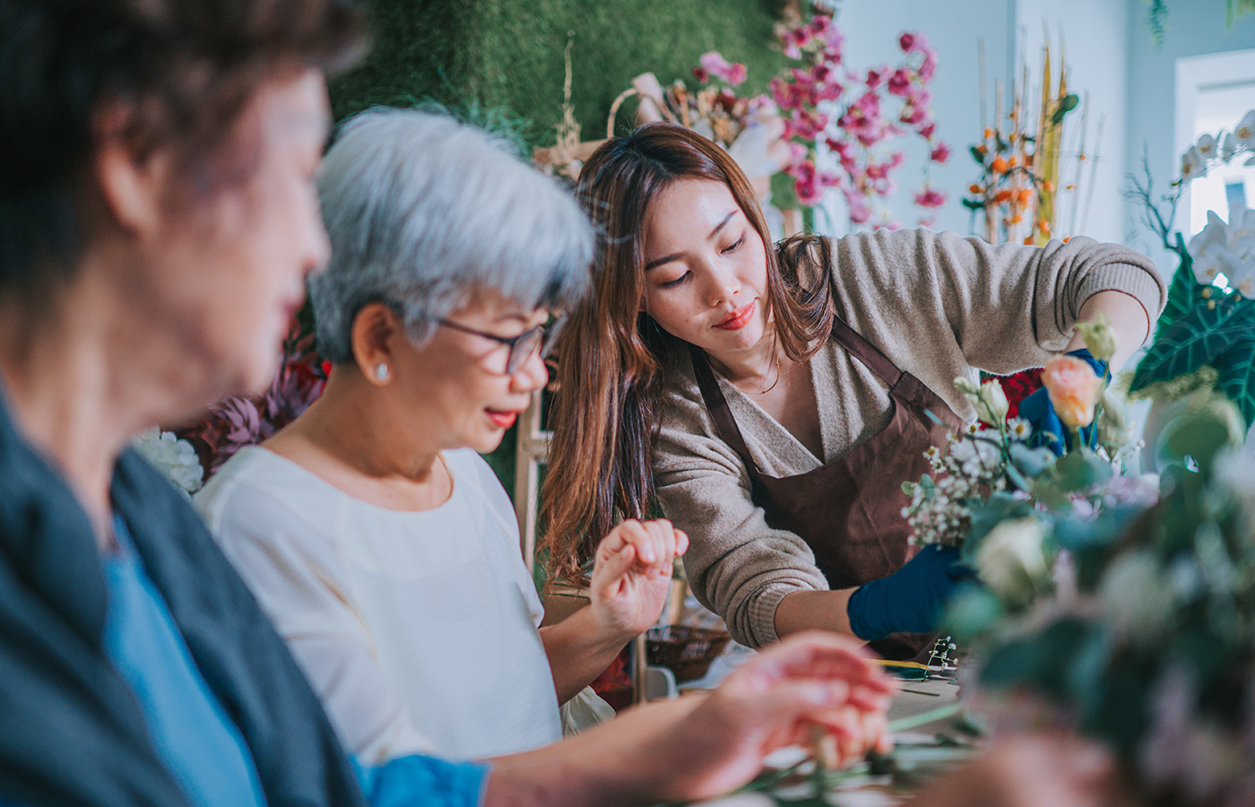 A group of people arranging flowers.