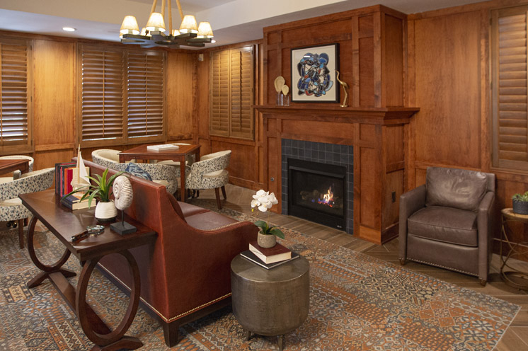 Wooden detailed sitting area in front of a fire place.