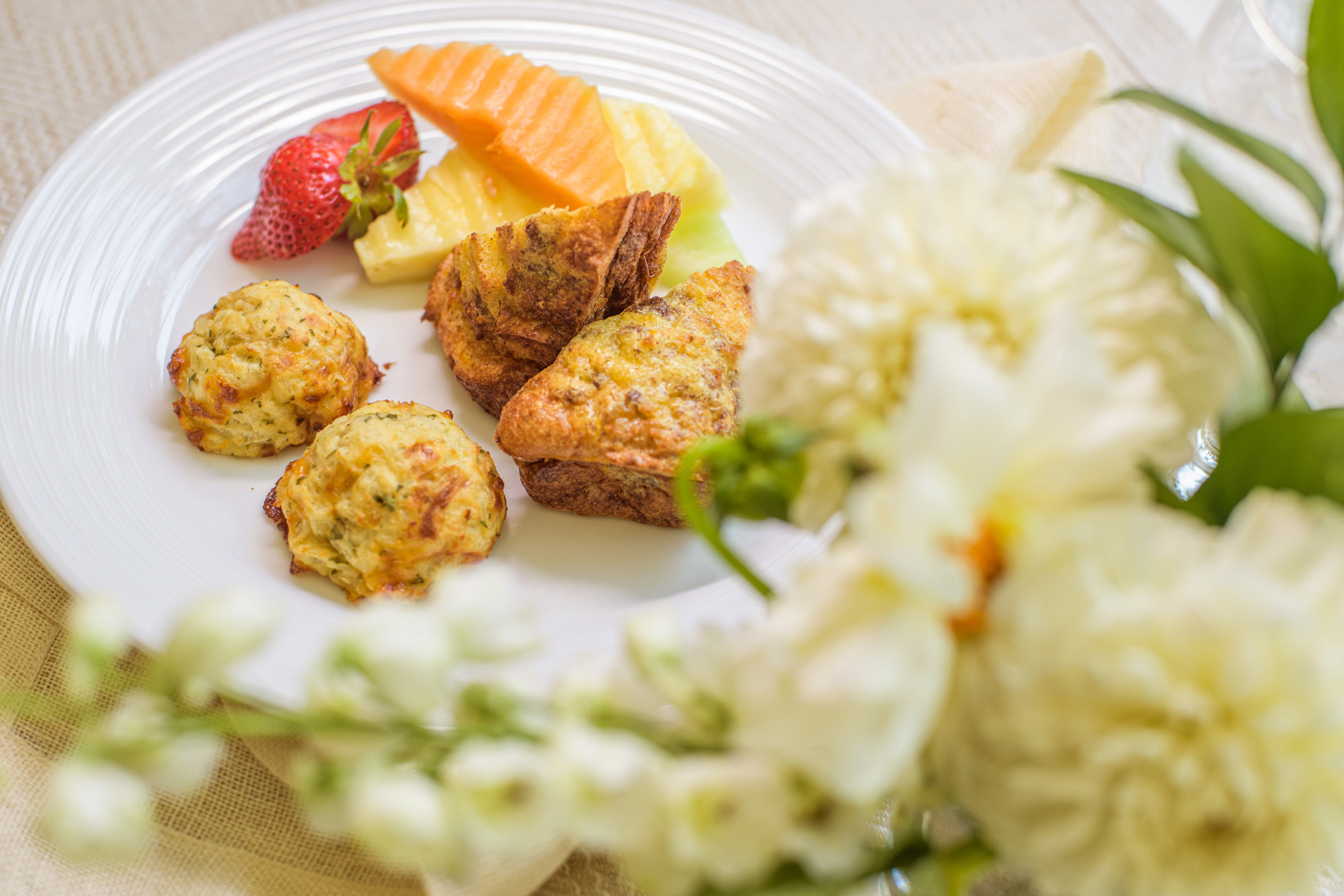 close up plate of assorted egg quiches and fruit