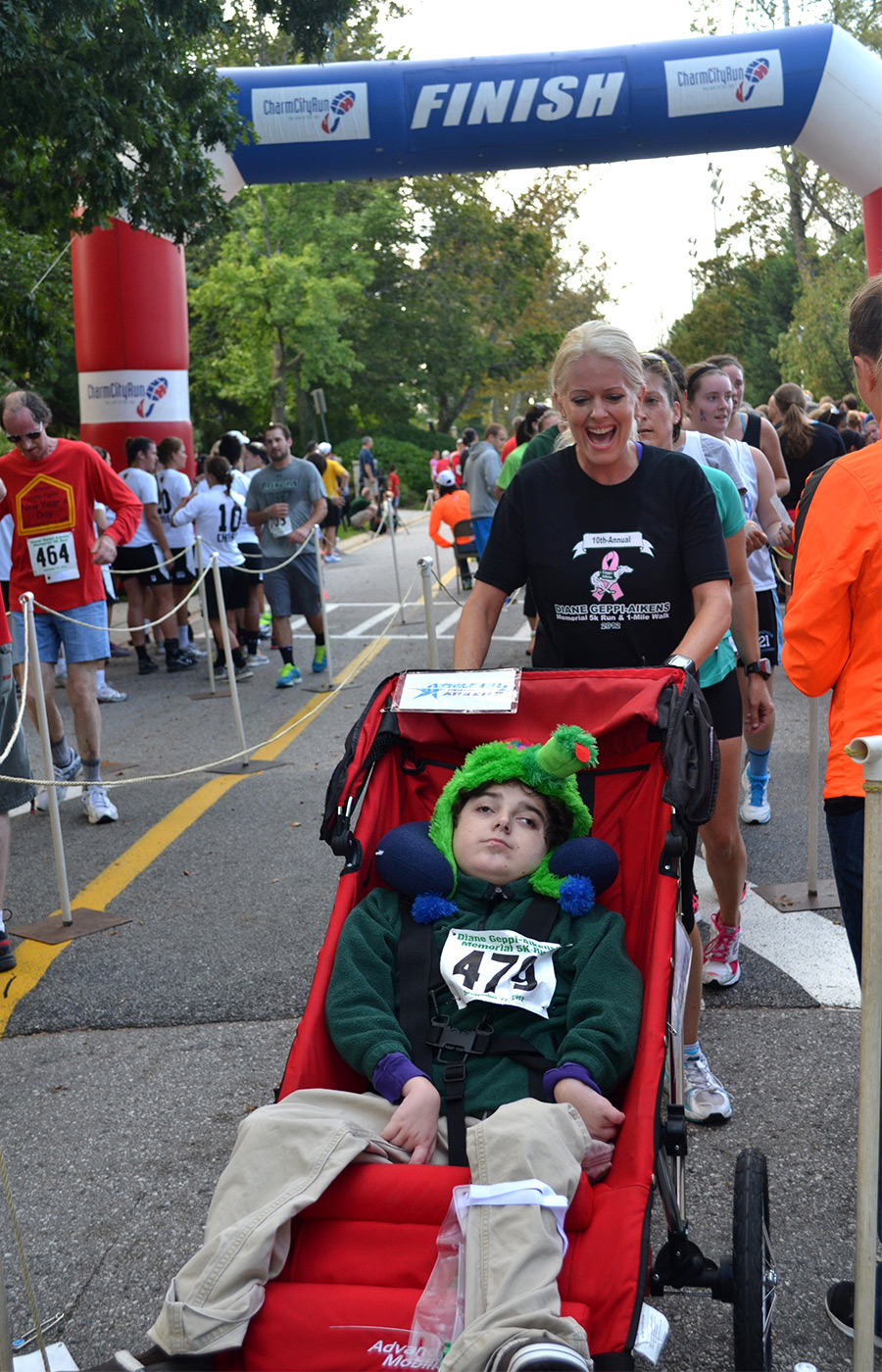 people crossing a finish line of a race