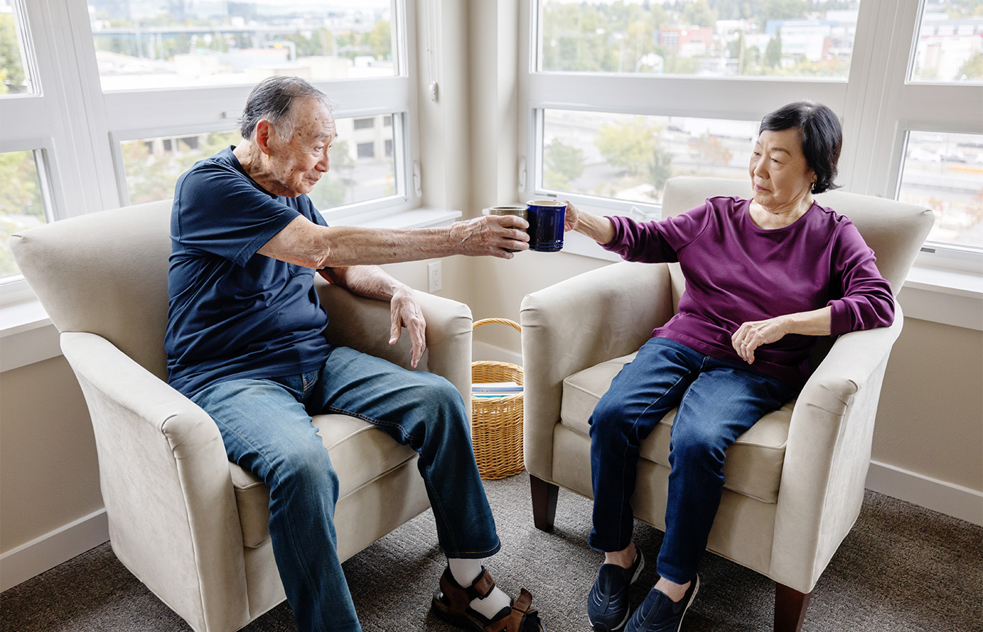 Two people having coffee in their apartment.