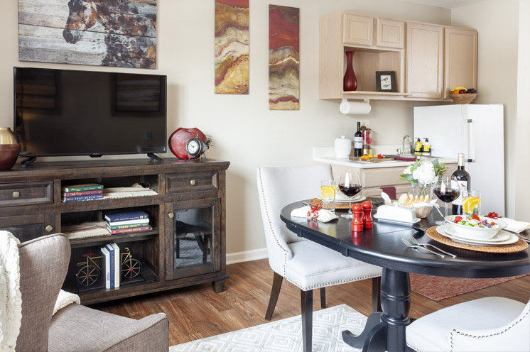 Furnished living room with table and tv.