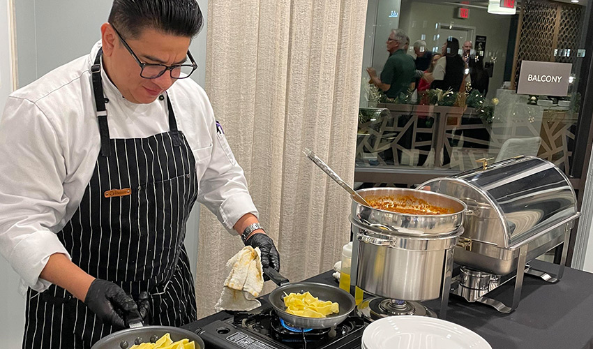 A chef cooking at a party.