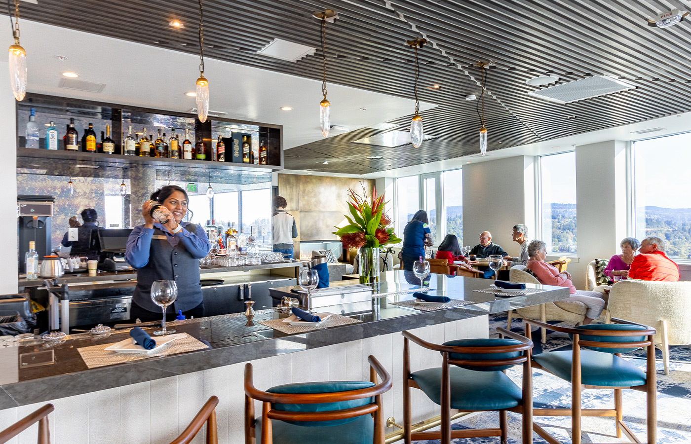 People in a lounge having drinks and food.