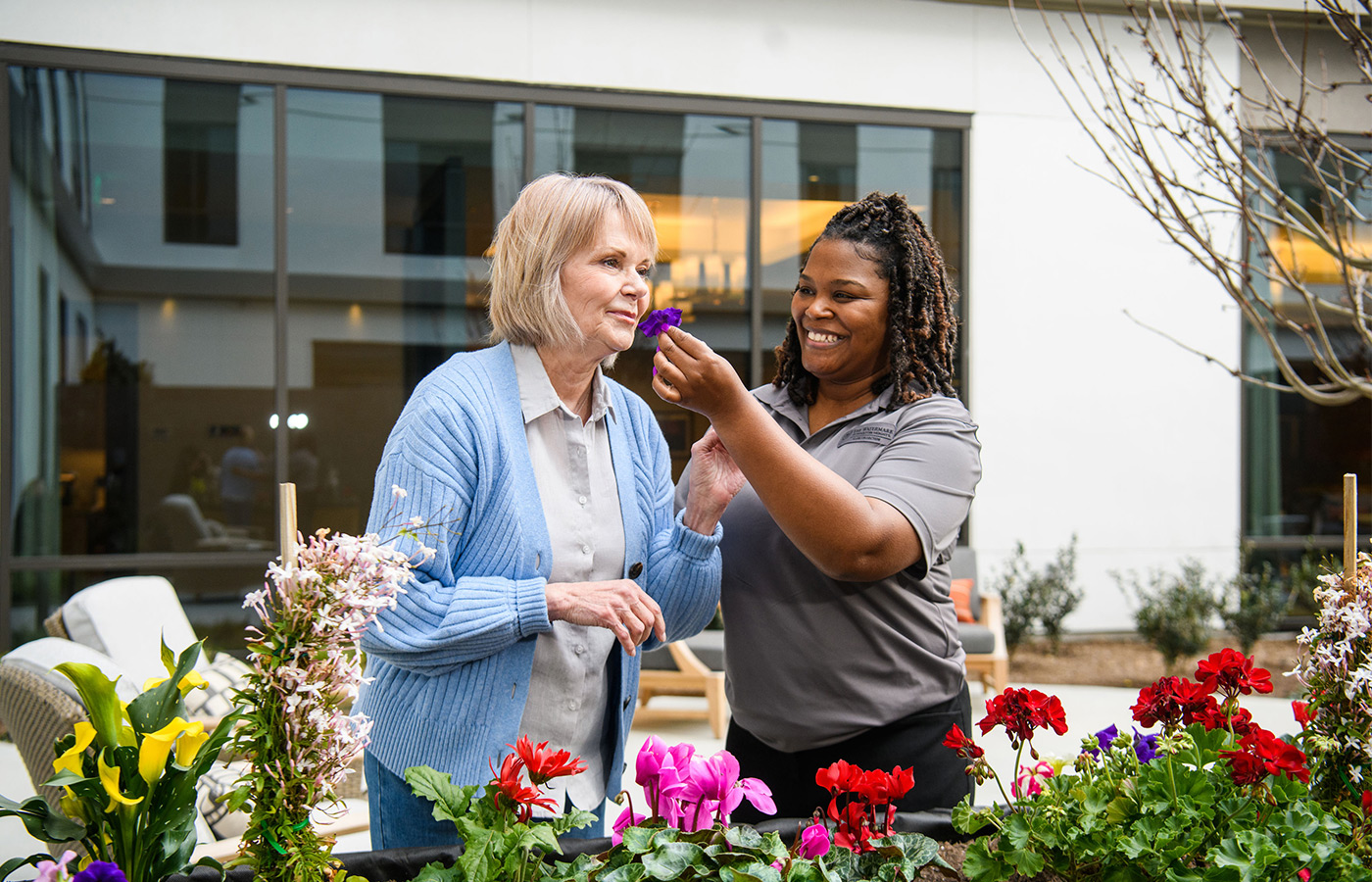 A person smelling a flower.