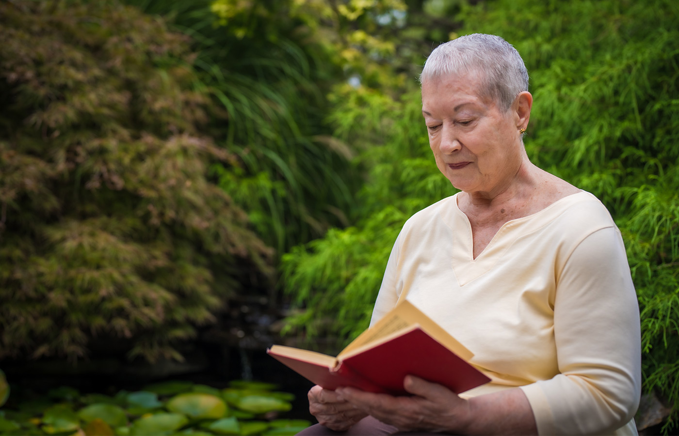 A person reading in the garden.