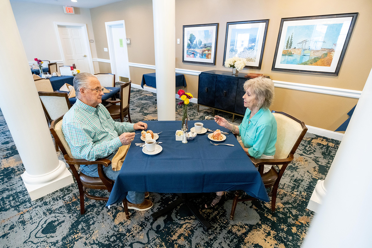 Residents are in the dining area at East Village Place.