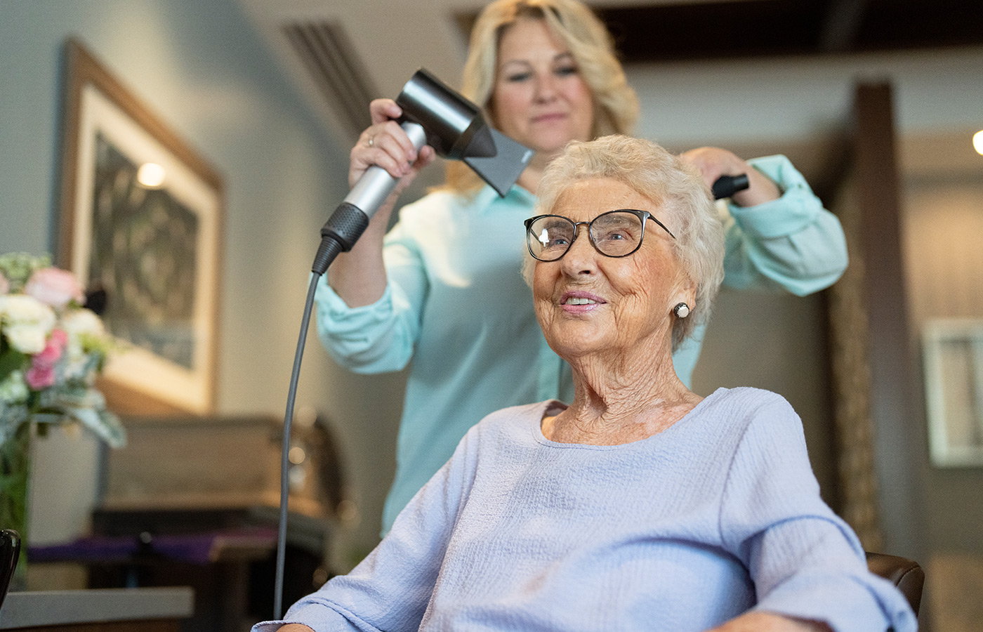 resident having their hair blow dried and styled at salon