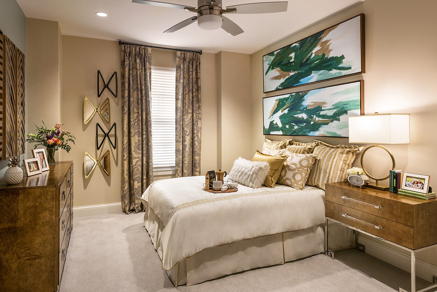 Decorated bedroom with bed, window, and dressers.