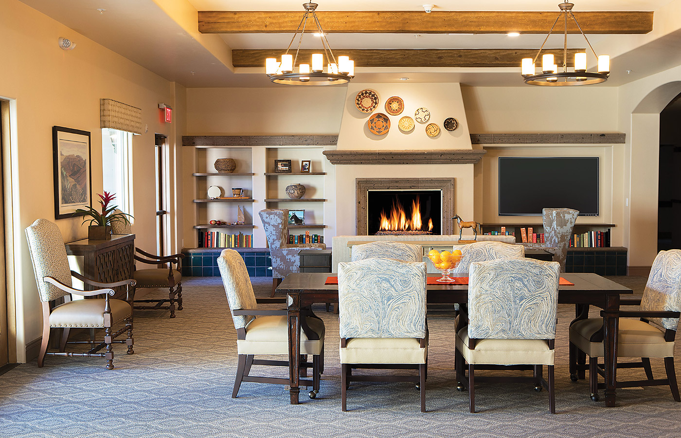 Seating area with sofas, chairs, and tables.