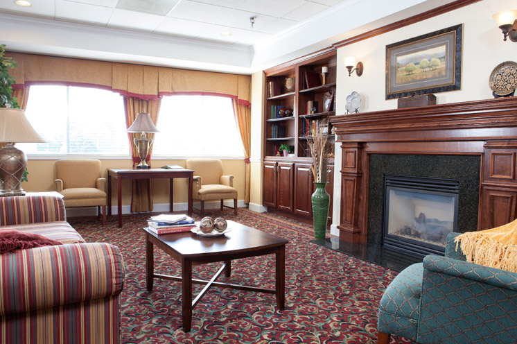 Furnished seating area with a fireplace. 