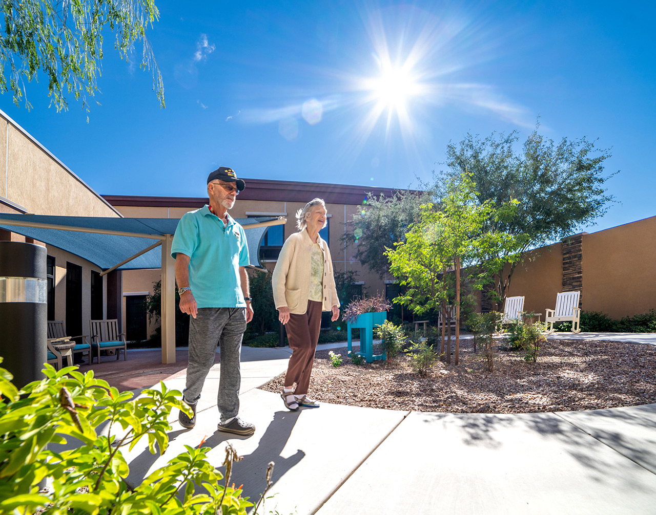 Two residents are walking through the courtyard.