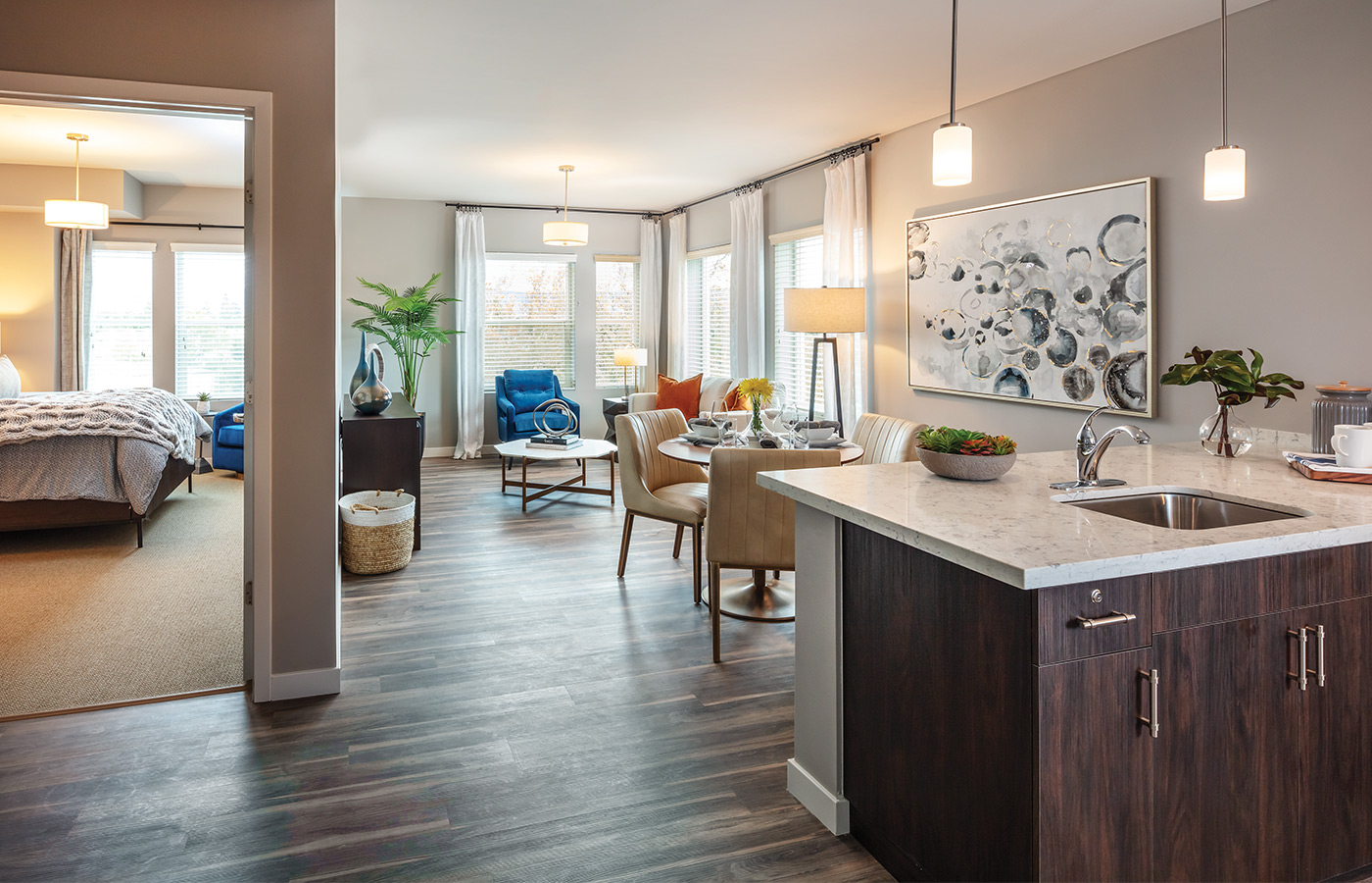 A fully furnished kitchen looking into the living room and bedroom.