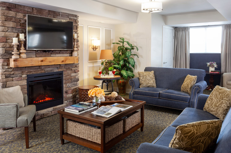 Seating area by fireplace at Pinebrook.