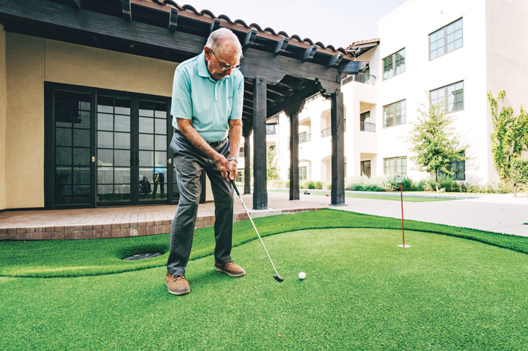 A resident plays golf.