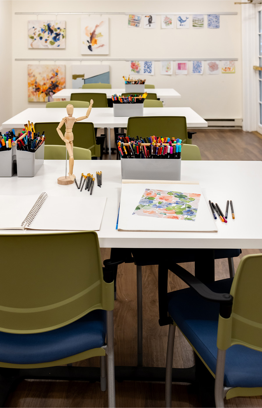 An art studio with supplies on the tables.